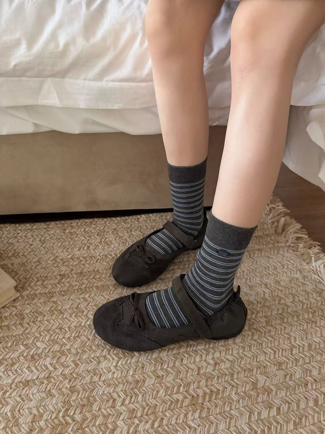 Striped dark gray crew socks worn with dark strap shoes
