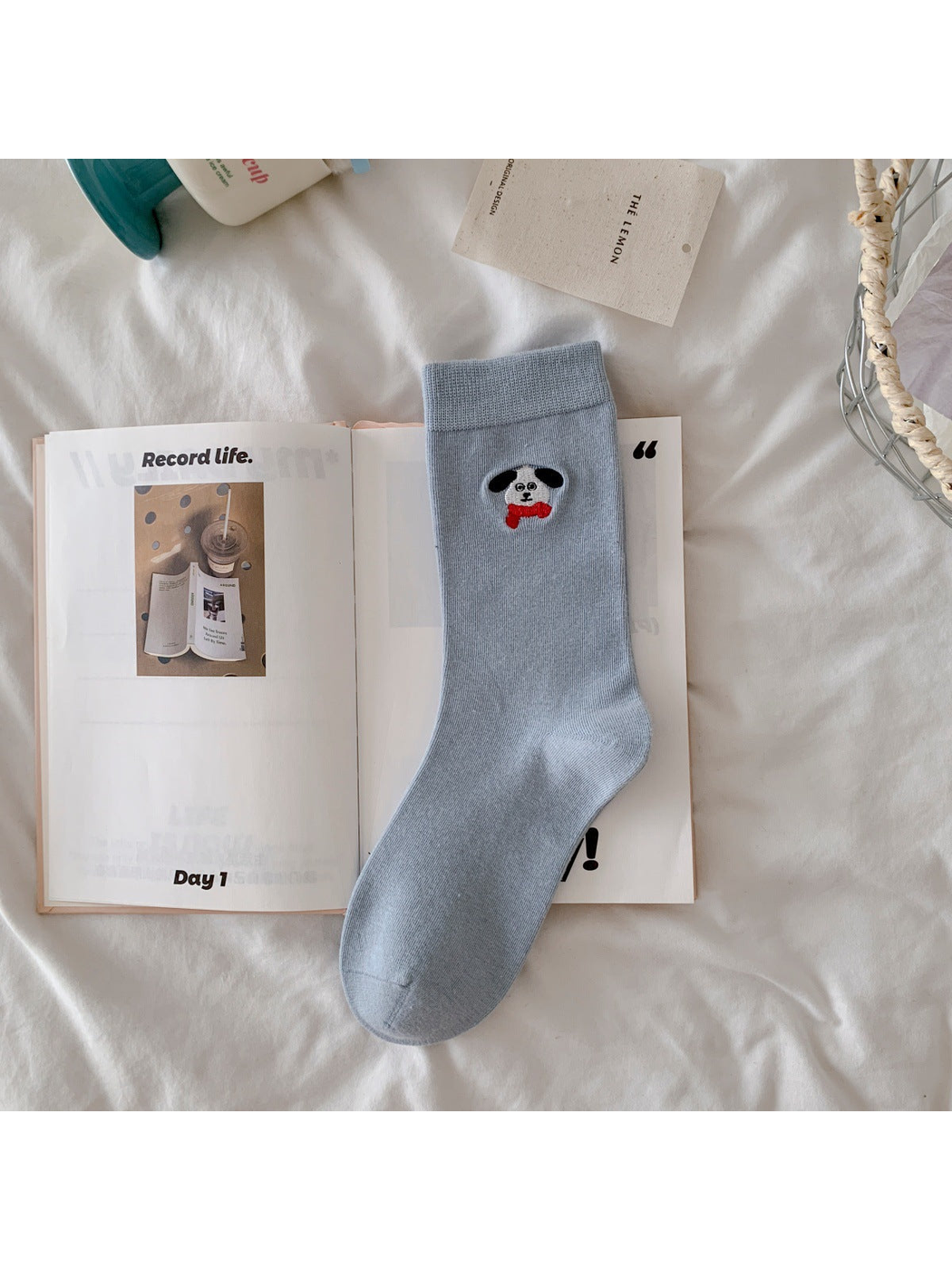 Light blue crew sock with embroidered dog and red bow tie