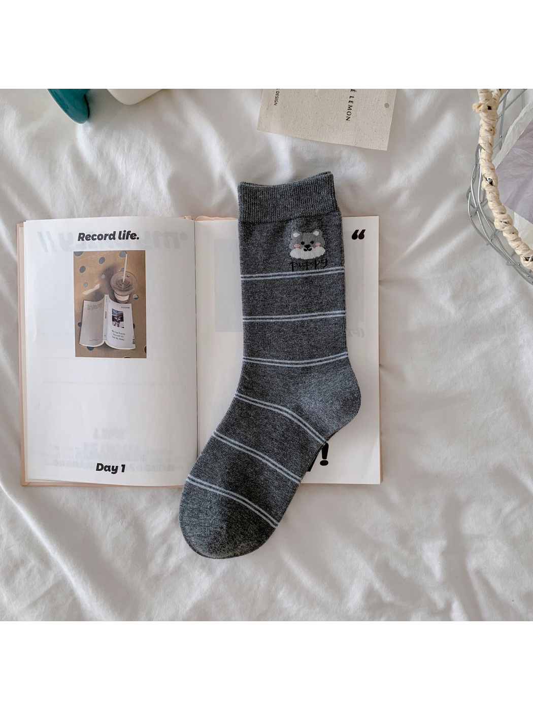 Dark gray crew sock with dog motif and narrow white stripes