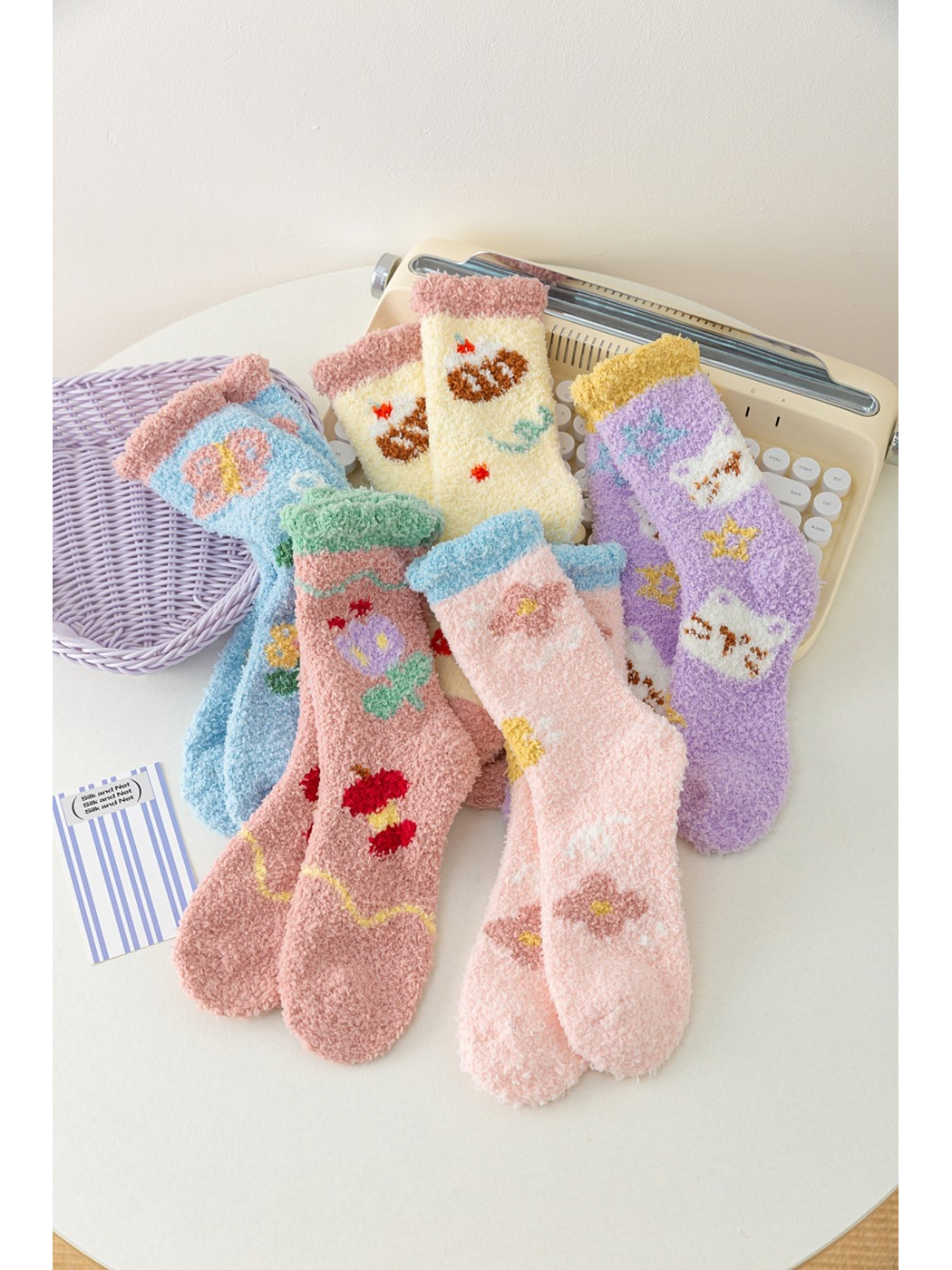 Five pairs of fuzzy patterned socks displayed together