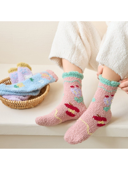 Dusty pink fuzzy floral socks worn while seated