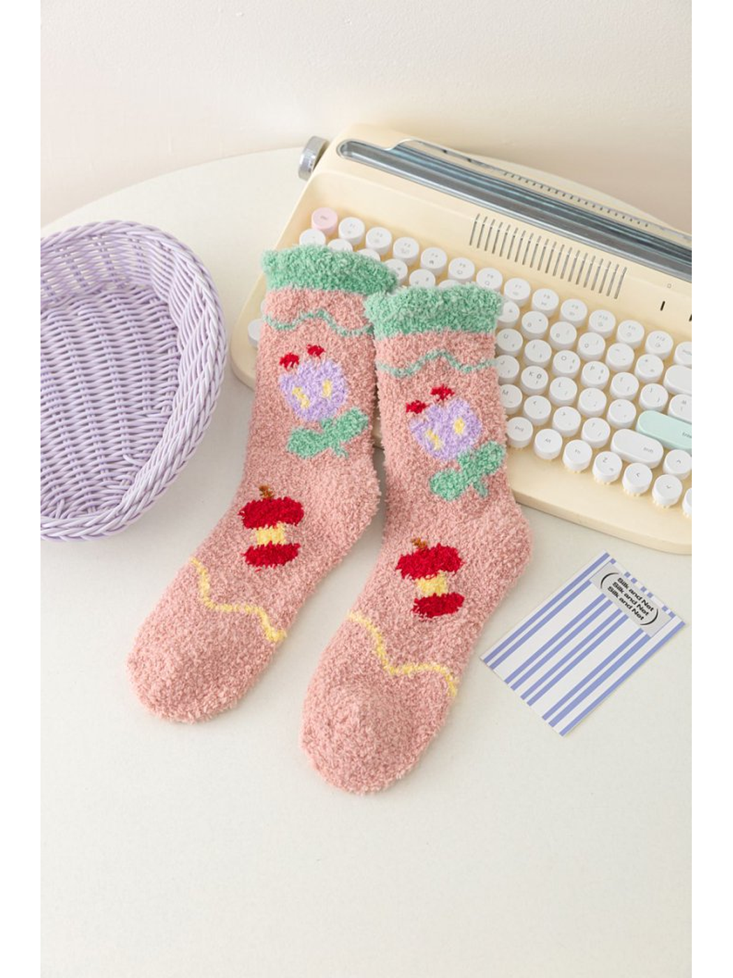 Dusty pink fuzzy socks with tulip motifs and green cuffs