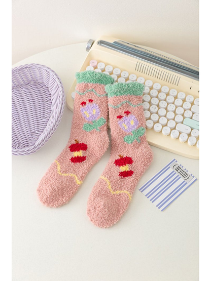 Dusty pink fuzzy socks with tulip motifs and green cuffs