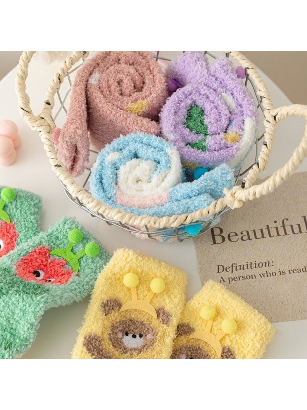 Rolled fuzzy socks showing contrasting colors and cartoon motifs