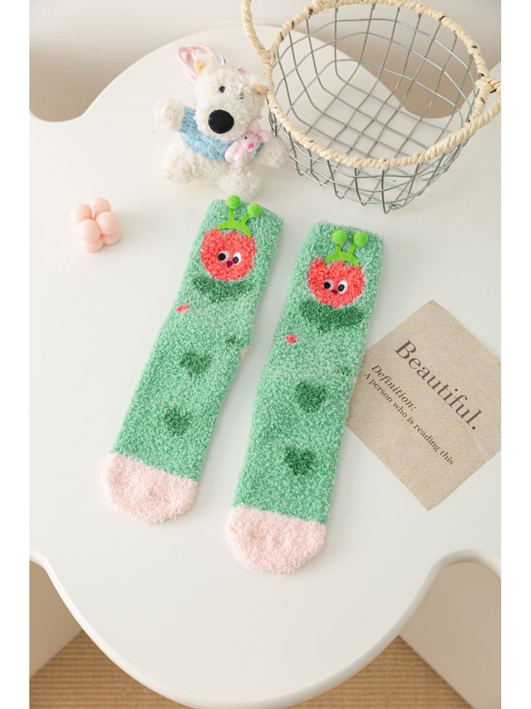 Mint green fuzzy socks with red fruit character motif and pink toes