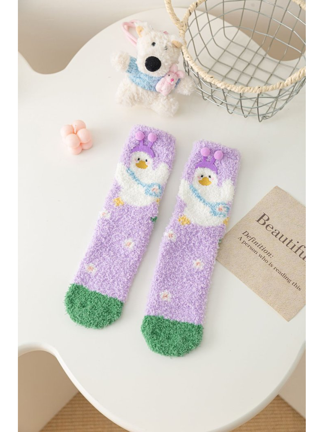 Light purple fuzzy socks with white duck motif and green toes