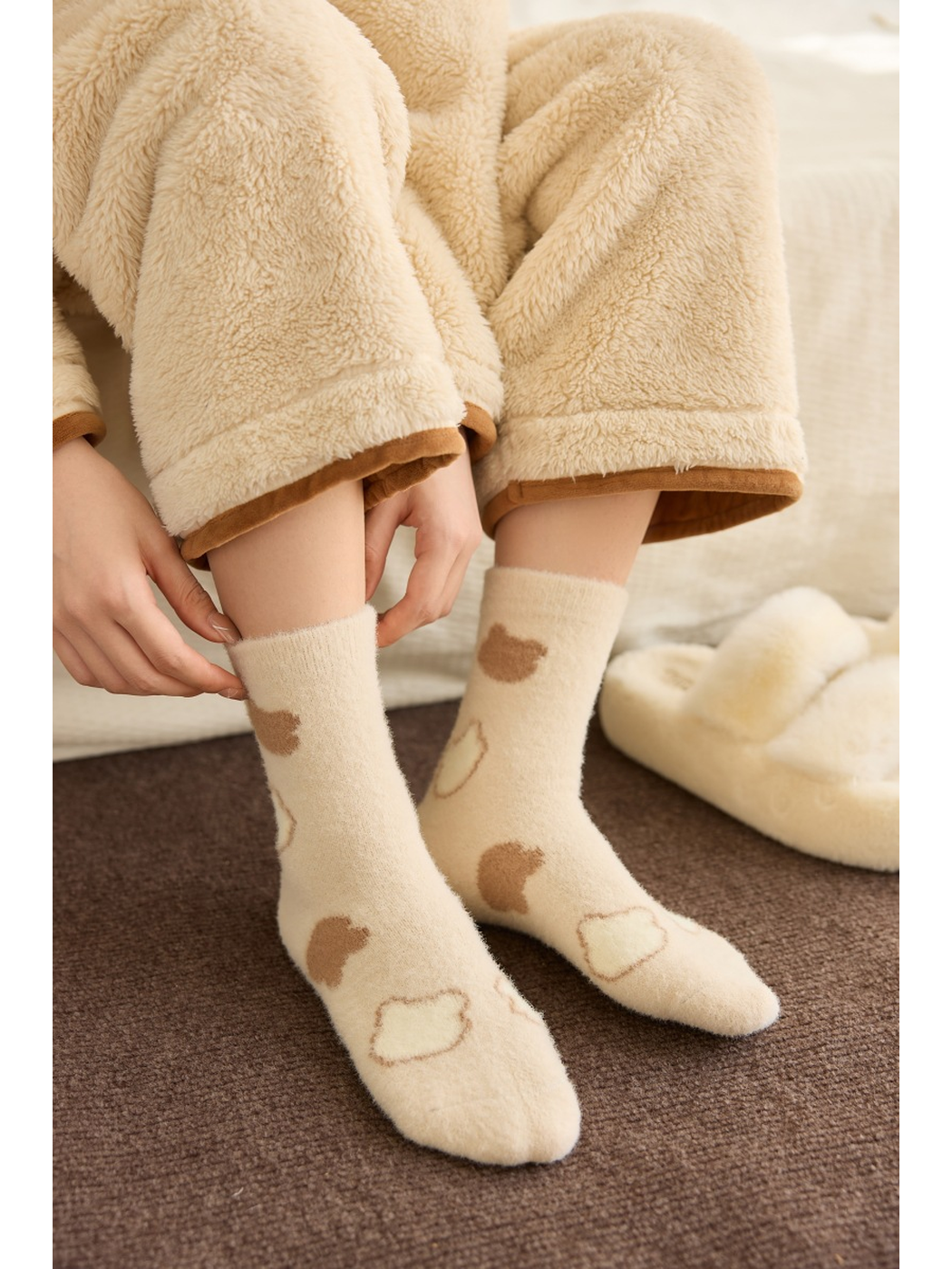 Ivory bread-pattern crew socks worn in a seated indoor scene