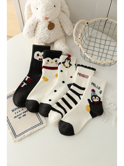 Five penguin crew sock designs displayed together with contrasting cuffs, toes and patterns