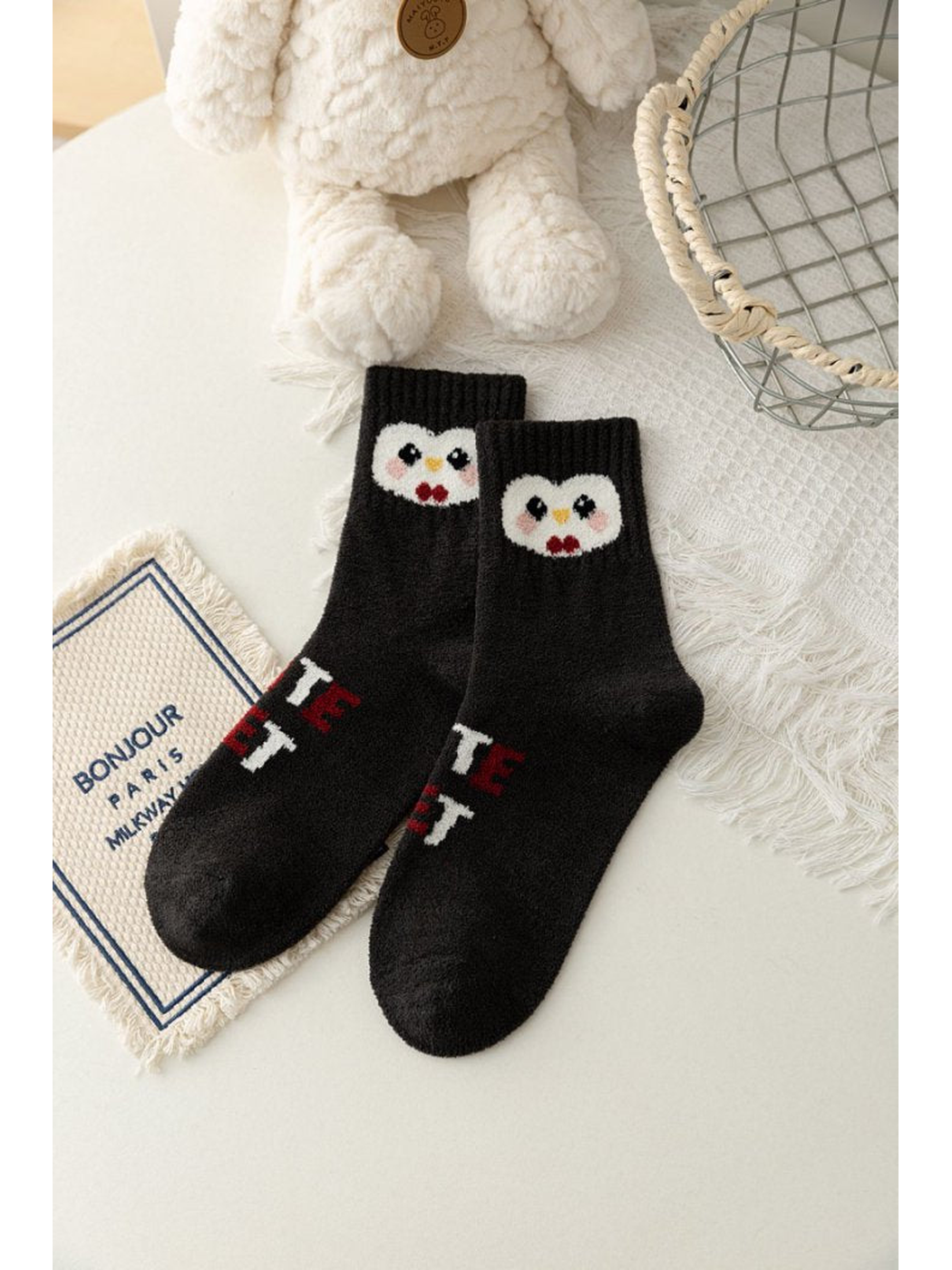 Black crew socks with contrasting penguin faces near the cuffs