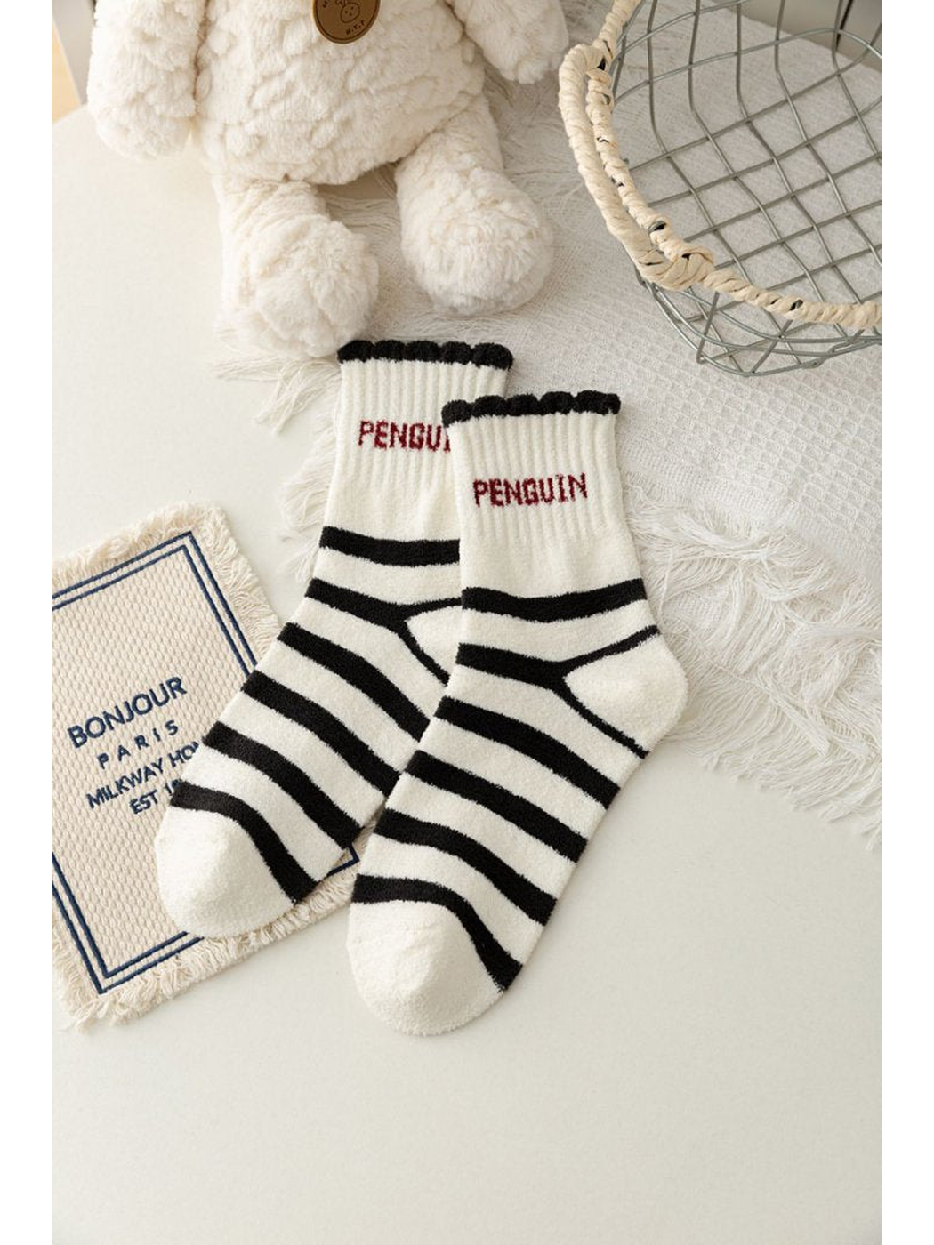 Ivory crew socks with black horizontal stripes and red penguin lettering