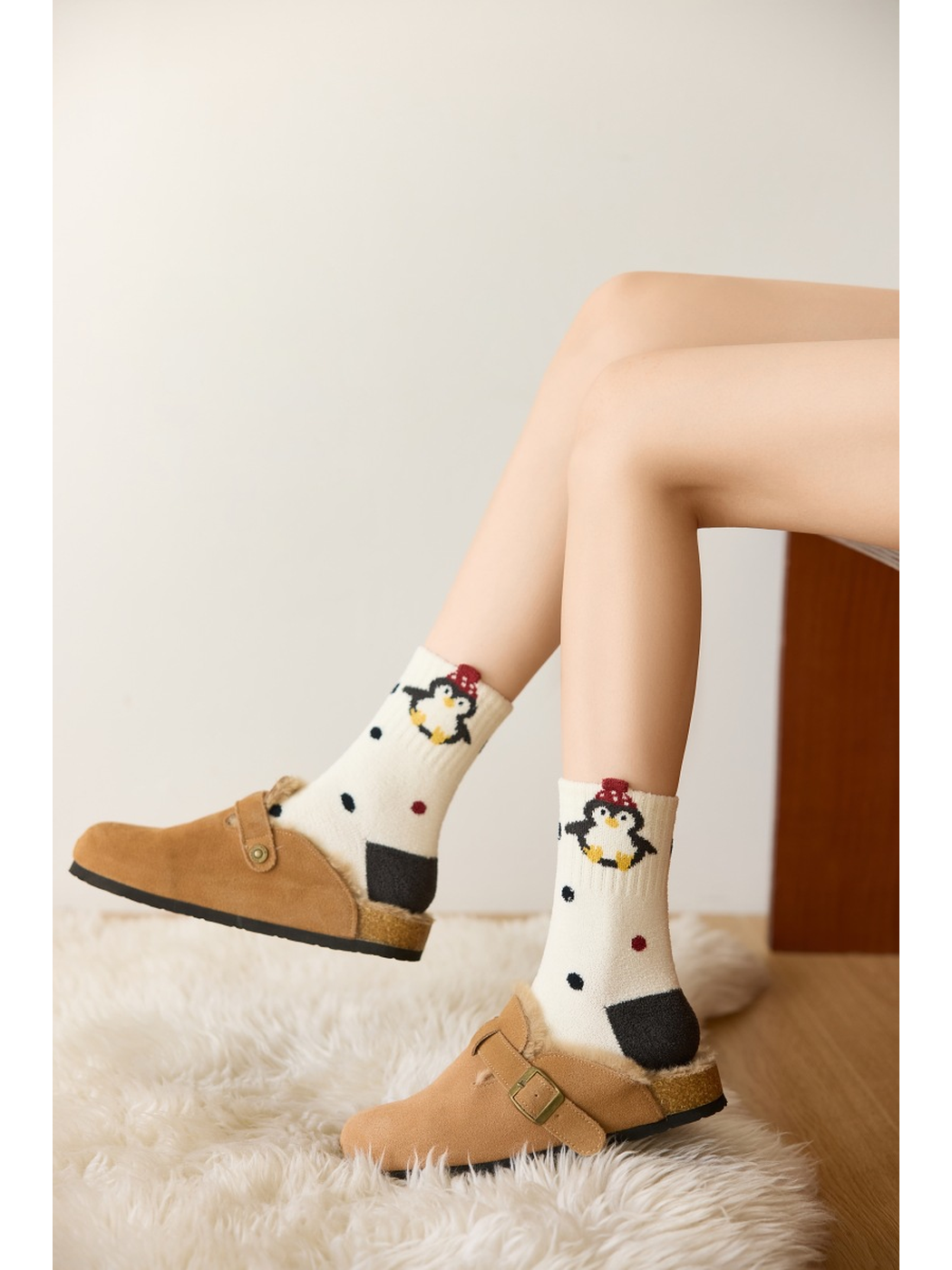 Ivory dotted penguin crew socks worn with tan buckle slippers