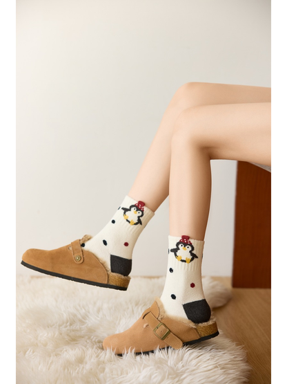 Ivory dotted penguin crew socks worn with tan buckle slippers