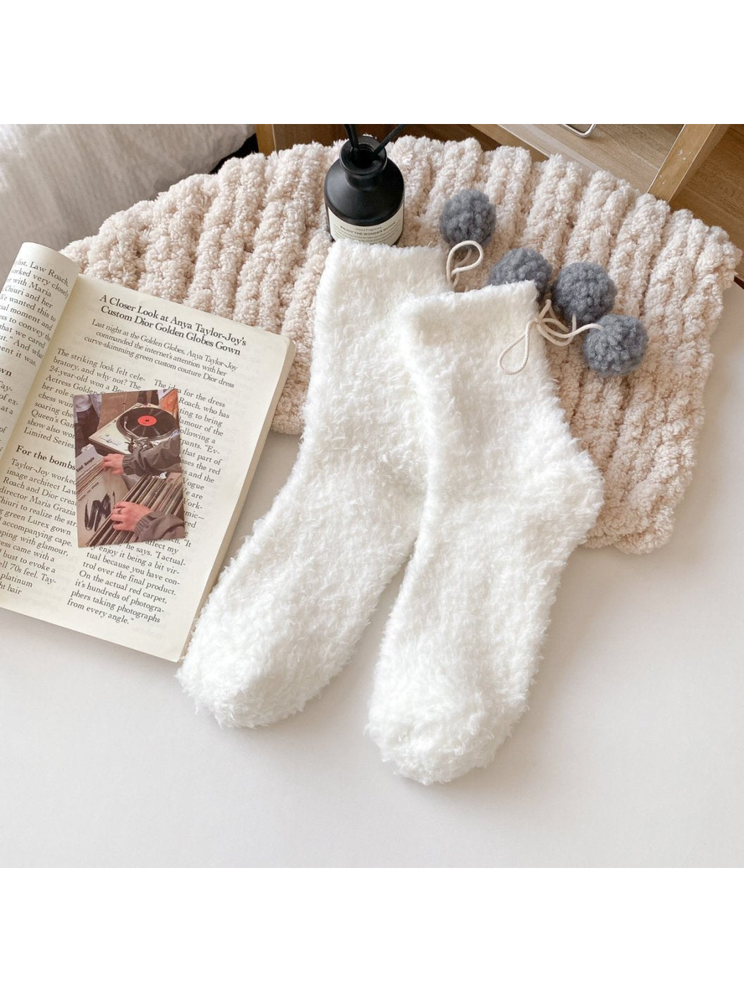 White fuzzy socks with gray pom-pom ties