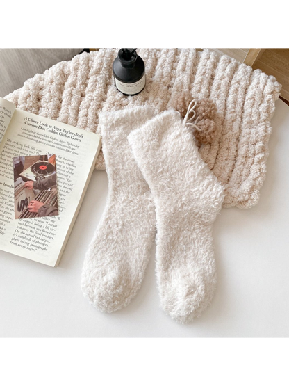 Ivory fuzzy socks with beige pom-pom ties