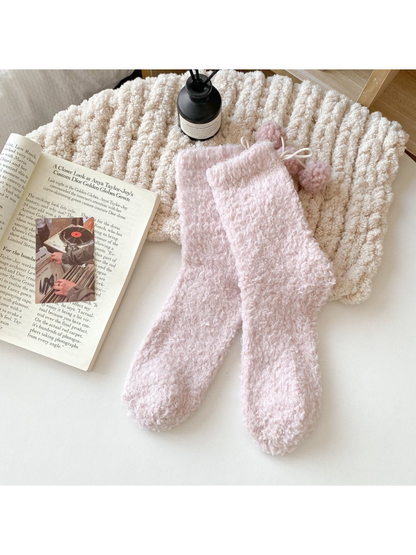 Light pink fuzzy socks with matching pom-pom ties