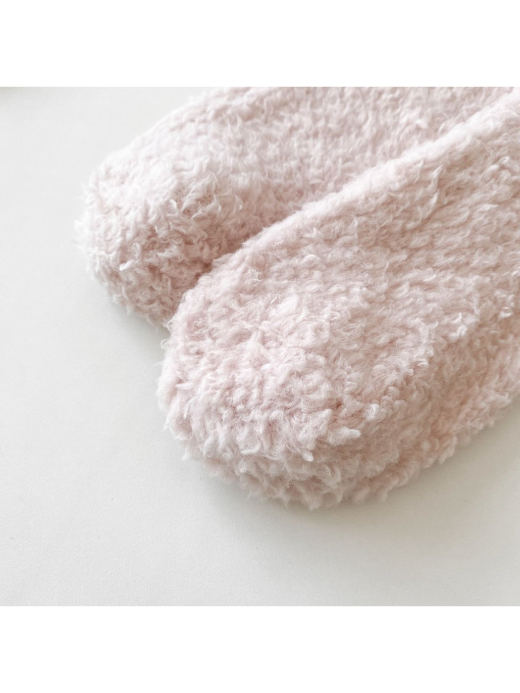 Close-up of the rounded toe and fuzzy surface in light pink