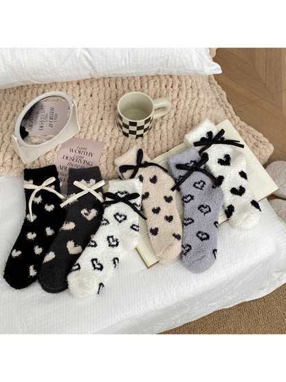 Assorted fuzzy heart-pattern socks displayed together