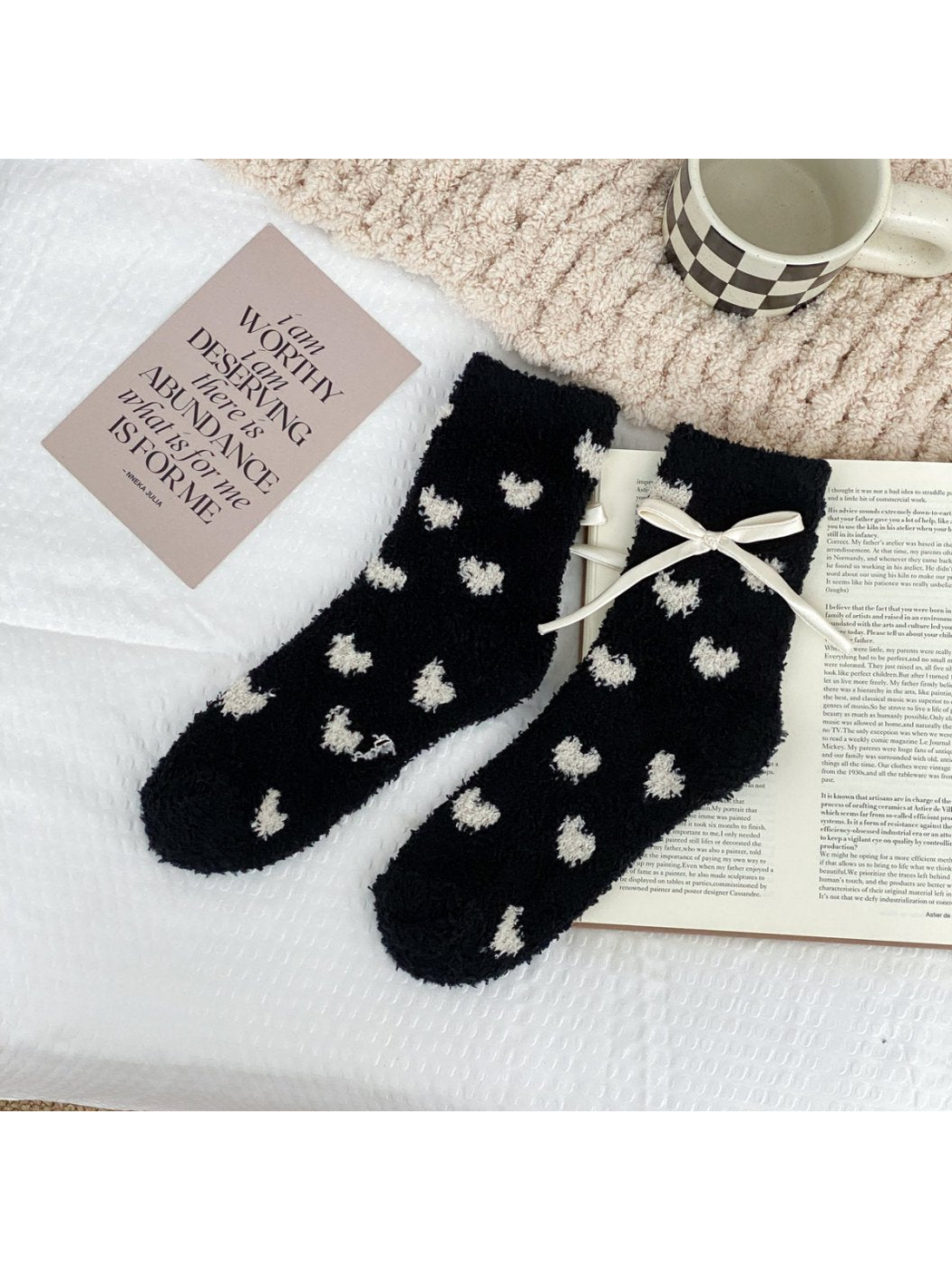 Black fuzzy socks with small cream hearts and a cream ribbon bow