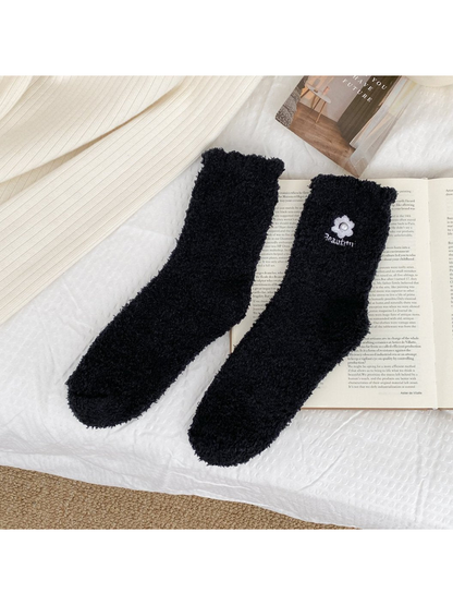 Black fuzzy crew socks with flower embroidery