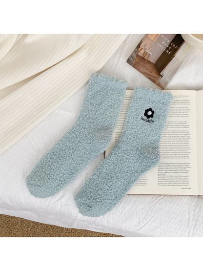 Pale blue-green fuzzy crew socks with flower embroidery