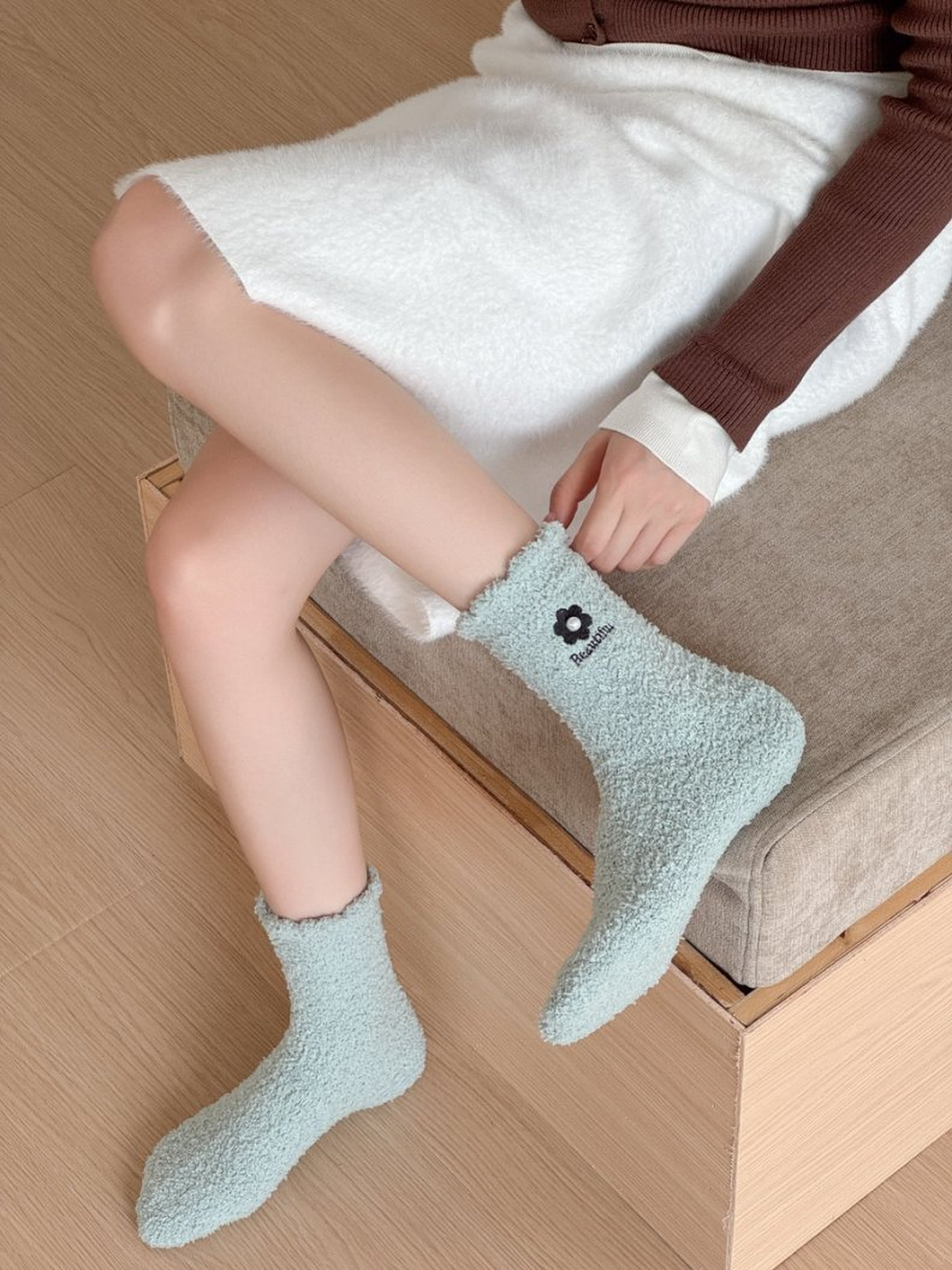 Pale blue-green fuzzy crew socks worn while seated