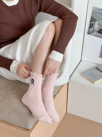 Light pink fuzzy crew socks worn while seated