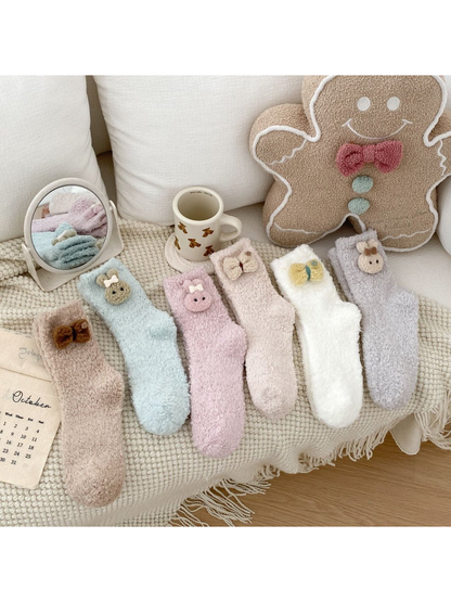Six fuzzy crew sock styles with decorative cuff appliques