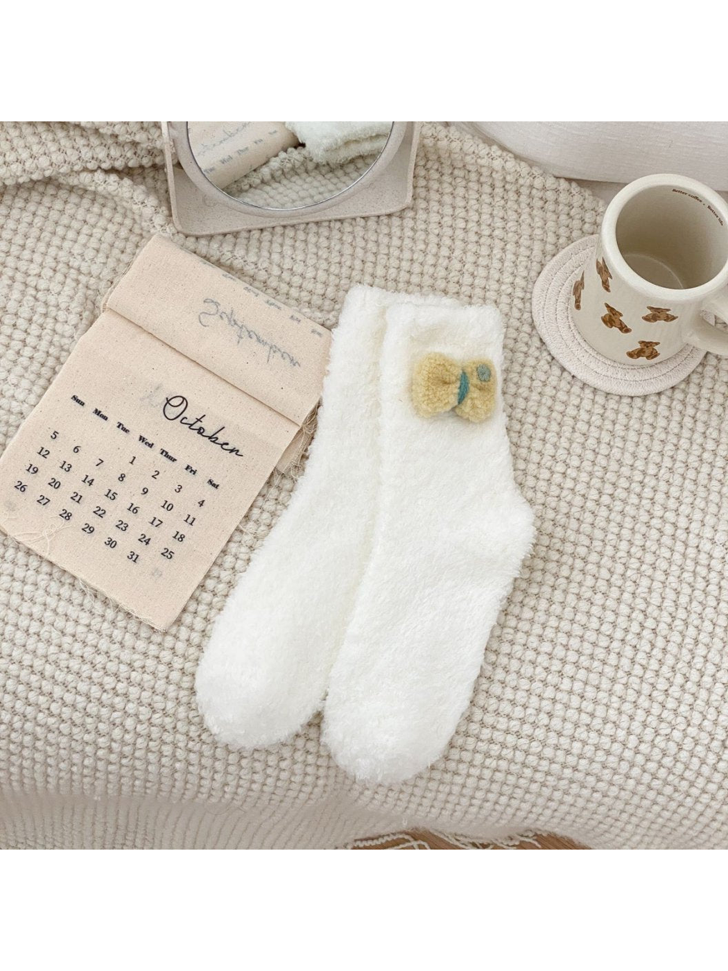 White fuzzy crew socks with a yellow bow applique