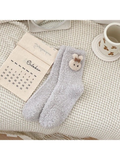 Light gray fuzzy crew socks with an animal-face applique