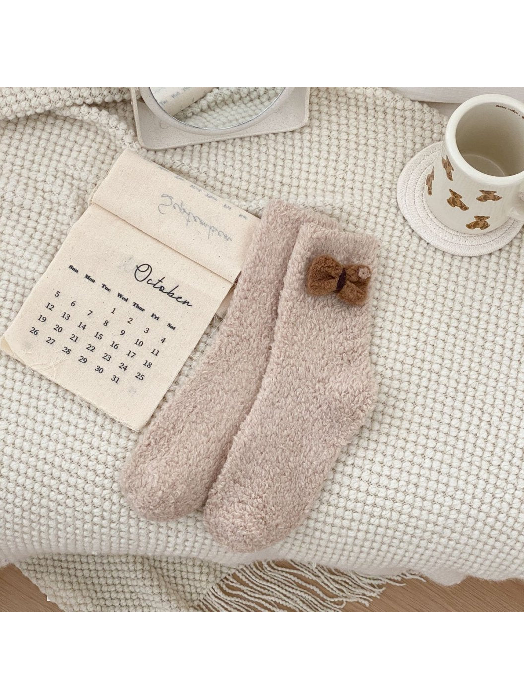 Greige fuzzy crew socks with a brown bow applique