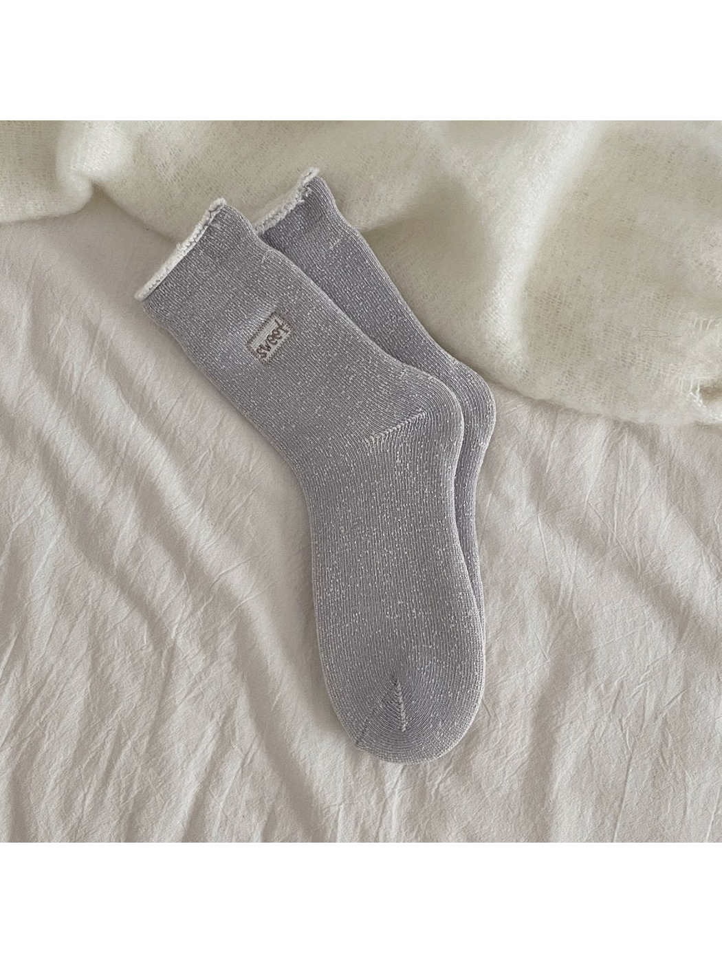 Dark gray ribbed crew socks with a rolled cuff and small label patch