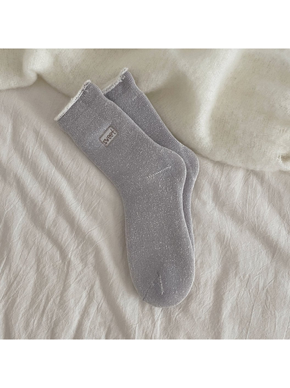 Dark gray ribbed crew socks with a rolled cuff and small label patch