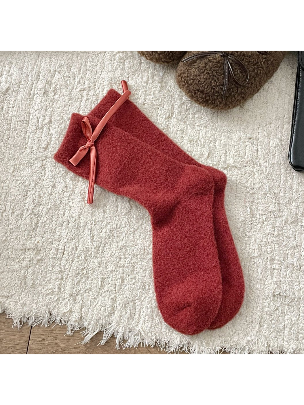 Red fuzzy crew socks with a matching ribbon bow