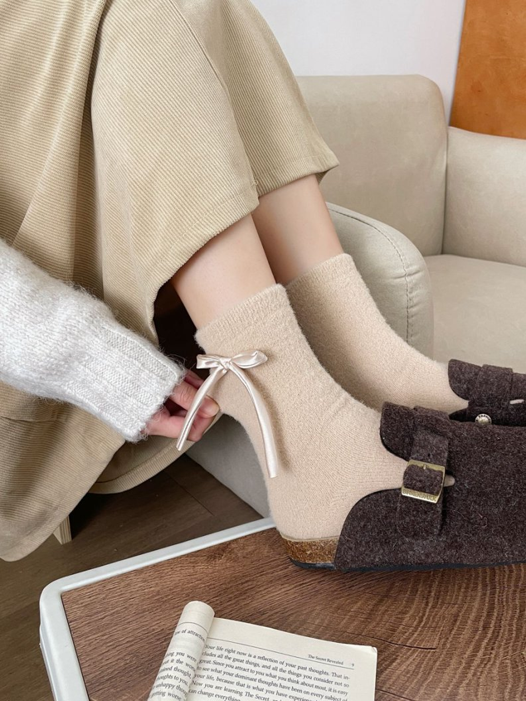 Beige ribbon-bow crew socks worn with brown buckle shoes