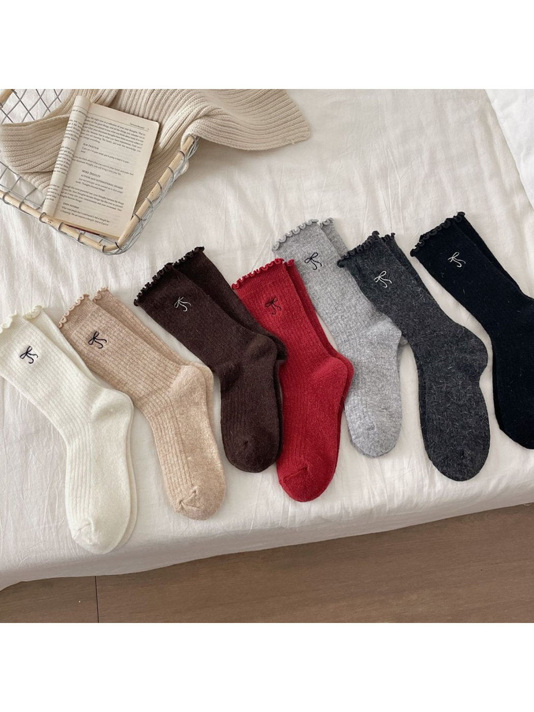 Seven colors of ribbed bow-motif socks displayed together