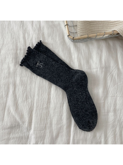 Dark gray ribbed crew socks with bow motif and ruffled cuffs