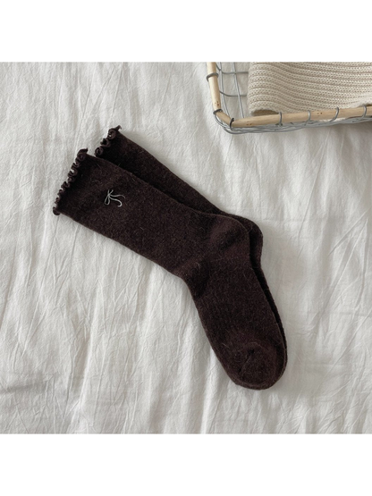 Dark brown ribbed crew socks with bow motif and ruffled cuffs