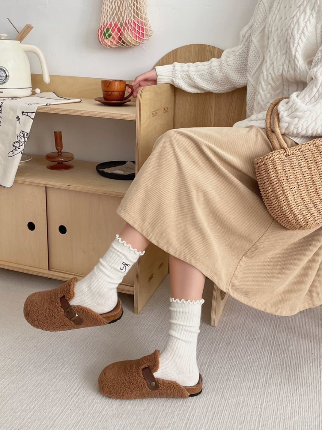 Ivory ruffled crew socks worn with brown slip-on shoes