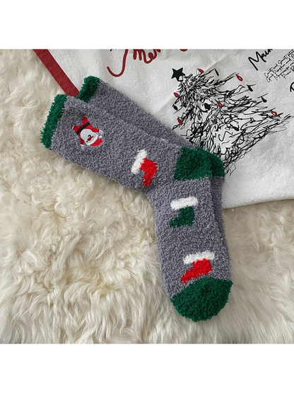 Gray fuzzy socks with green and red stocking motifs and embroidered Santa