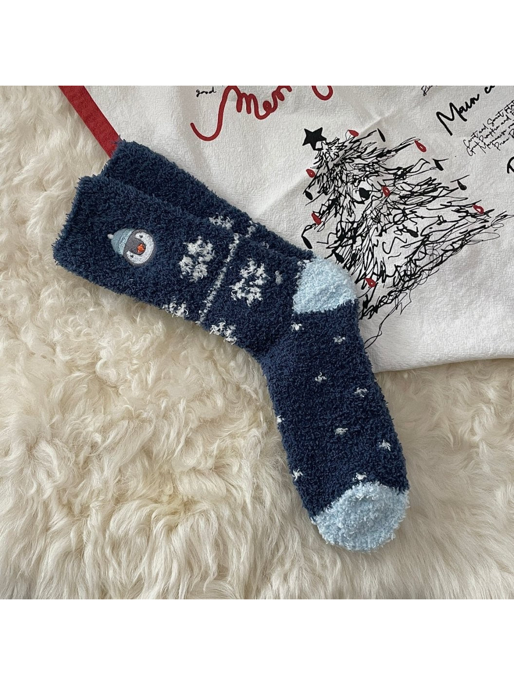 Navy fuzzy socks with snowflakes and embroidered penguin