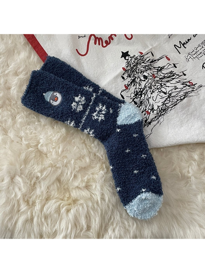 Navy fuzzy socks with snowflakes and embroidered penguin