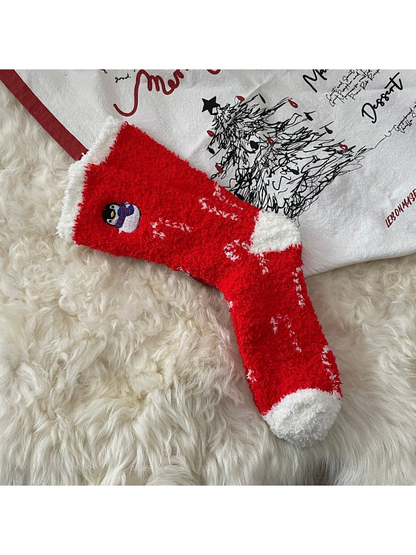 Red fuzzy socks with white trim and embroidered penguin