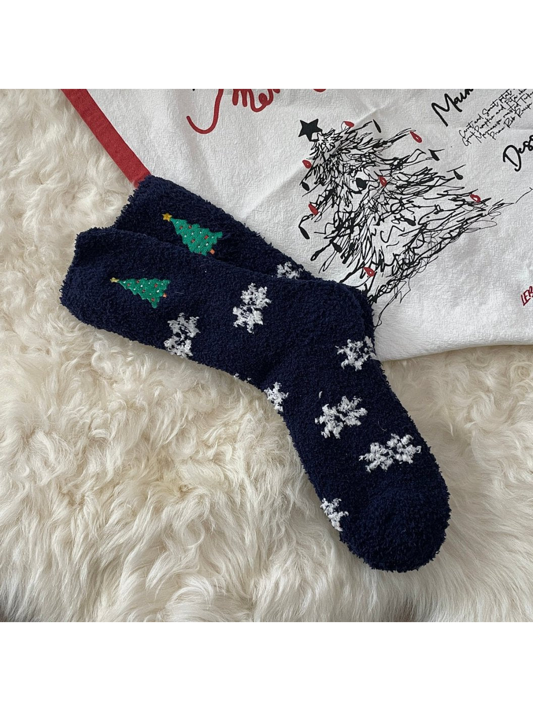 Navy fuzzy socks with Christmas trees and white snowflakes