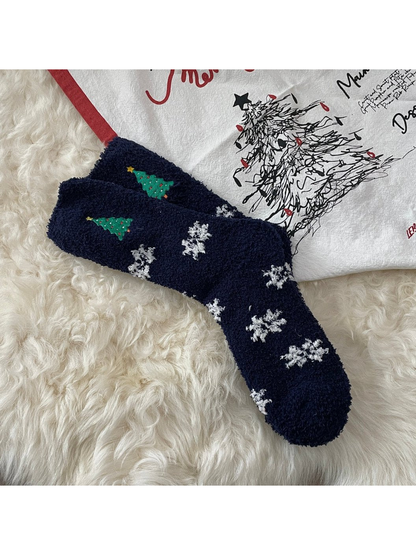 Navy fuzzy socks with Christmas trees and white snowflakes