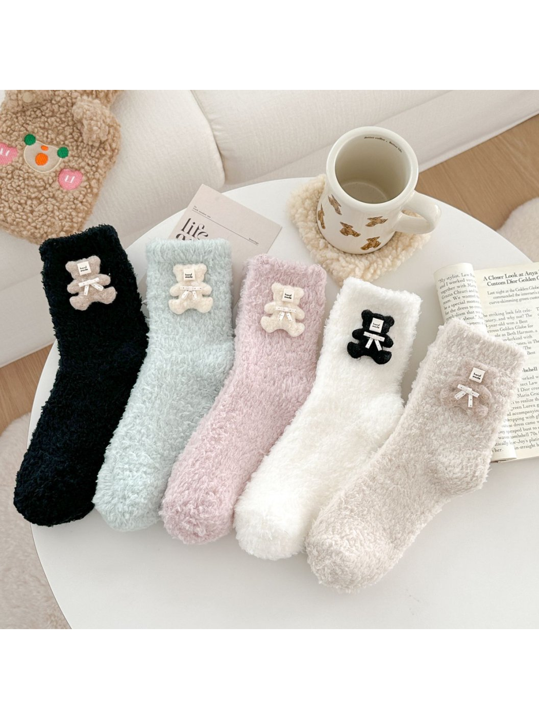 Five fuzzy socks with teddy bear appliques in black, pale blue, pink, white and beige