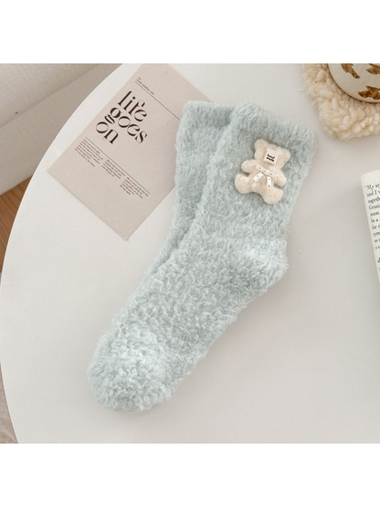 Pale blue-green fuzzy sock with ivory teddy bear applique