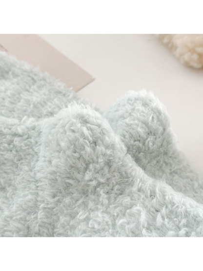 Close-up of the pale blue-green sock's fuzzy surface texture