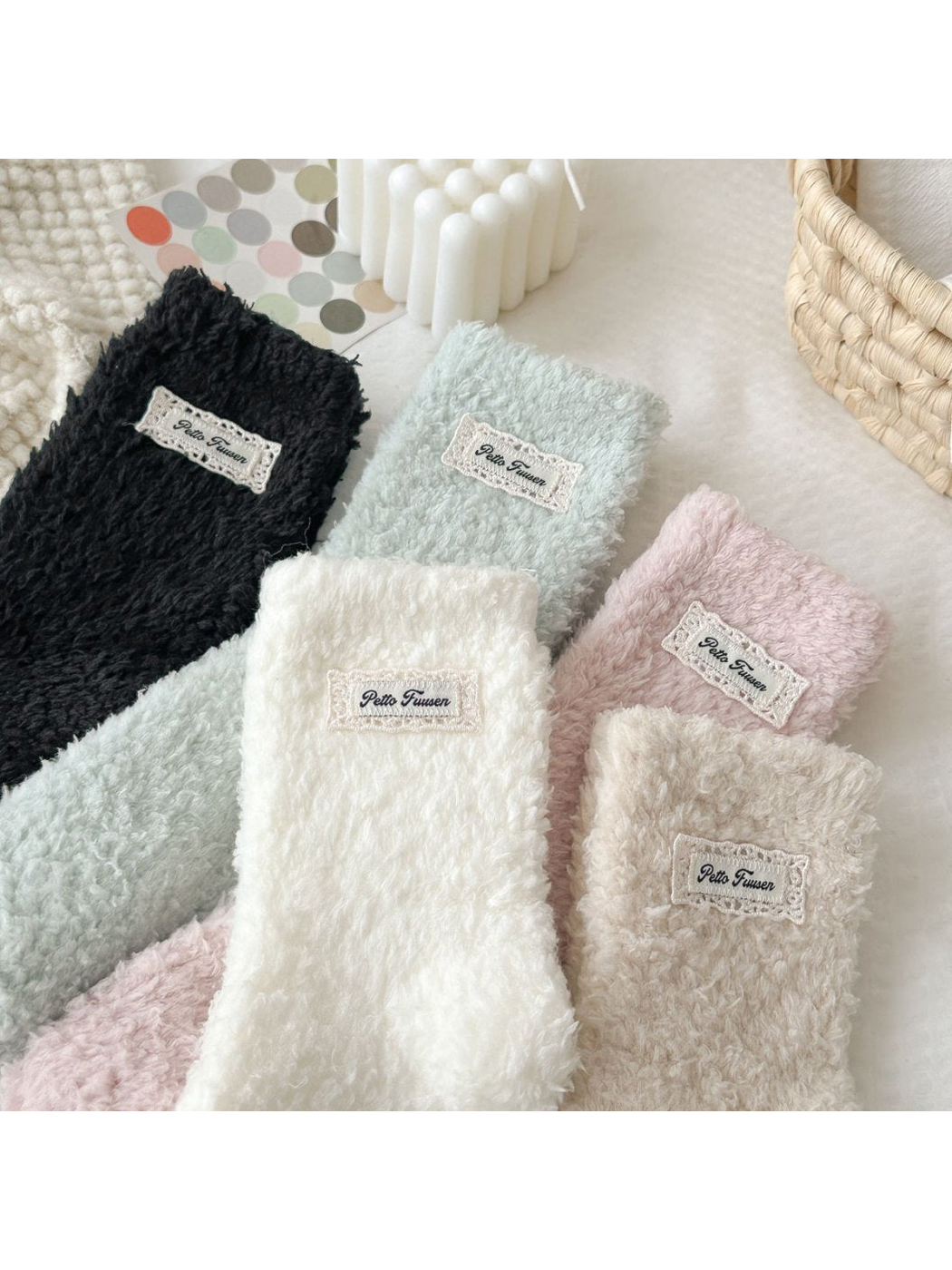 Close overview of fuzzy socks in five colors with rectangular label patches