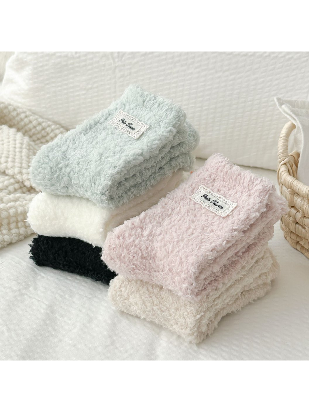 Folded stacks of fuzzy socks in five colors