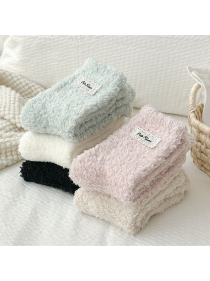 Folded stacks of fuzzy socks in five colors